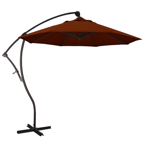 A brown California Umbrella cantilever umbrella with a Pacifica brick canopy on a metal stand.