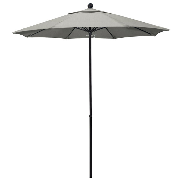A California Umbrella with a Sunbrella Oceanside canopy on a gray pole.