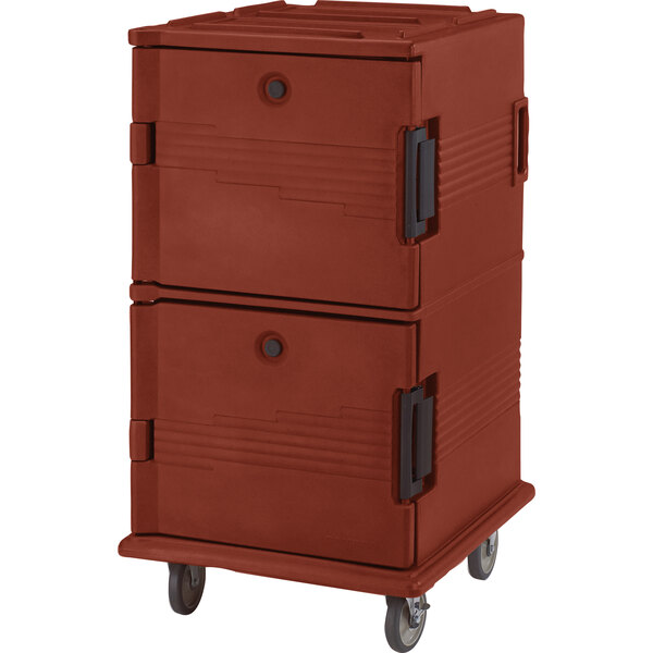A red plastic Cambro food pan carrier on wheels.