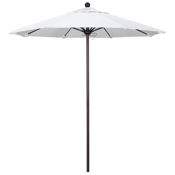 A white California Umbrella on a bronze pole.