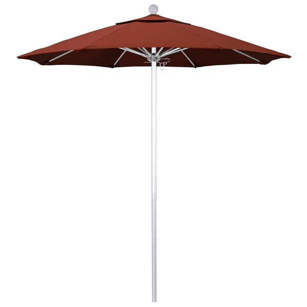 A red California Umbrella on a silver pole.
