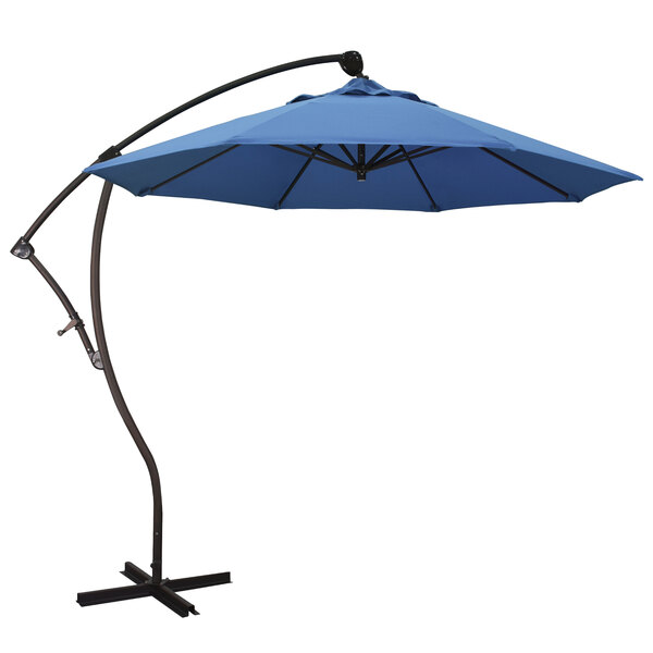 A blue California Umbrella cantilever umbrella with a black pole and Capri canopy.