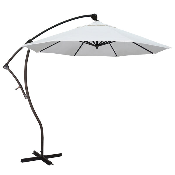 A natural fabric Pacifica canopy on a white California Umbrella with a black pole.