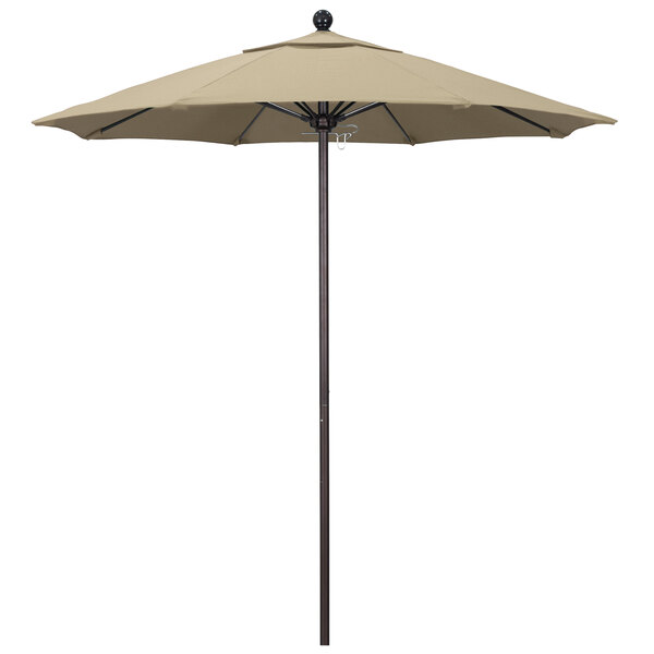 A tan California Umbrella on a bronze pole with an antique beige canopy.