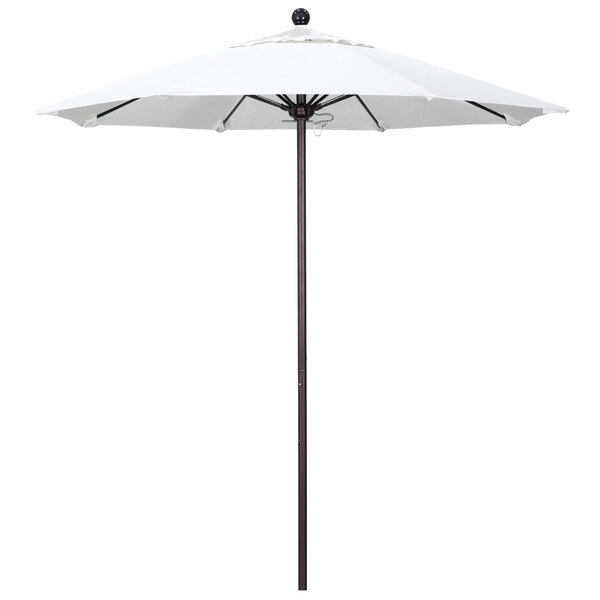 A white California Umbrella on a bronze pole.