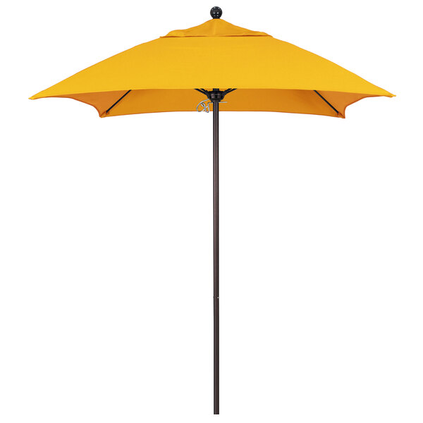 A yellow umbrella with a bronze pole on a white background.