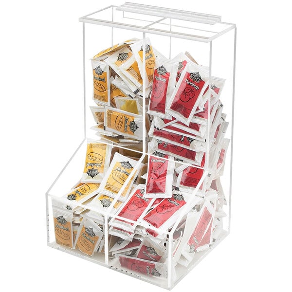 A clear plastic Cal-Mil condiment holder with two bins holding condiment packets.