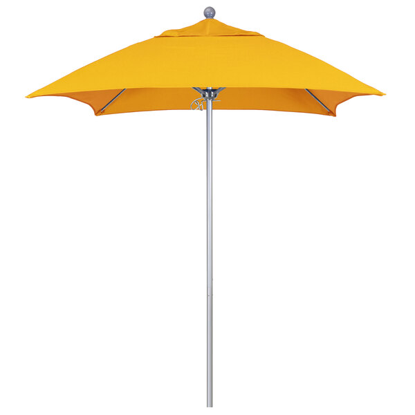 A California Umbrella ALTO yellow Sunbrella umbrella on a silver pole.