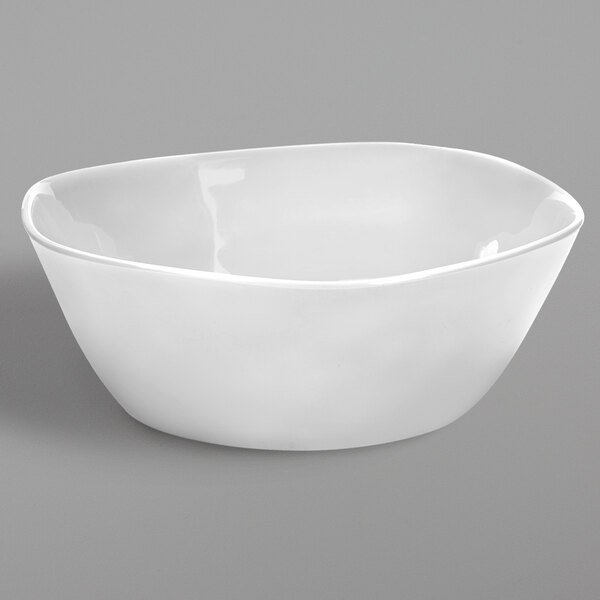 An American Metalcraft white melamine serving bowl with a small rim on a gray background.
