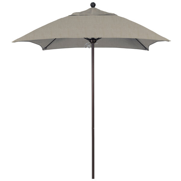 A California Umbrella square patio umbrella with a bronze pole and beige canopy.