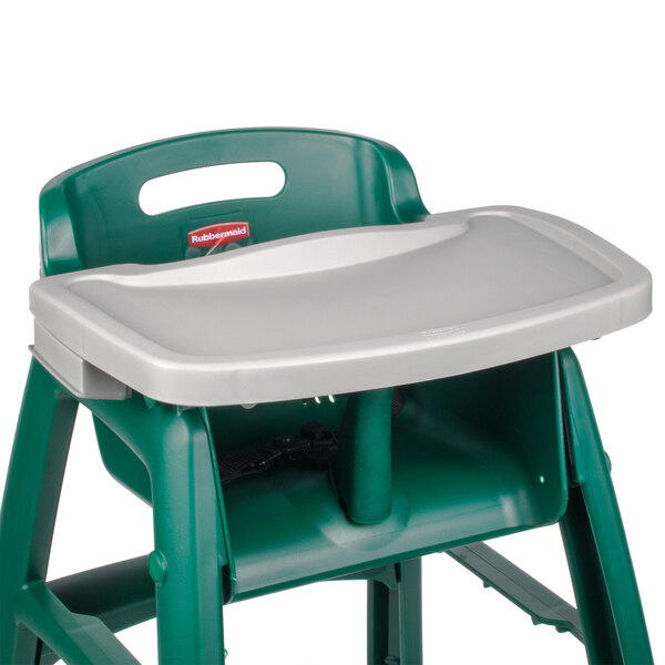 A green high chair with a grey tray.