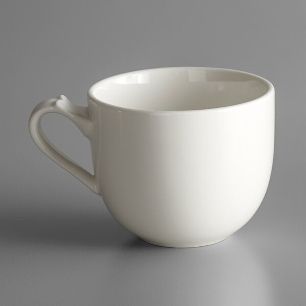 A white coffee cup with a handle.
