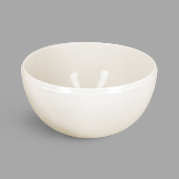 A RAK Porcelain white bowl on a white surface with a shadow.