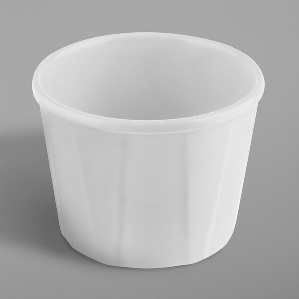 A white plastic Tablecraft Melamine souffle cup.