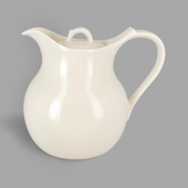 A close up of a white RAK Porcelain coffee pot with a handle.