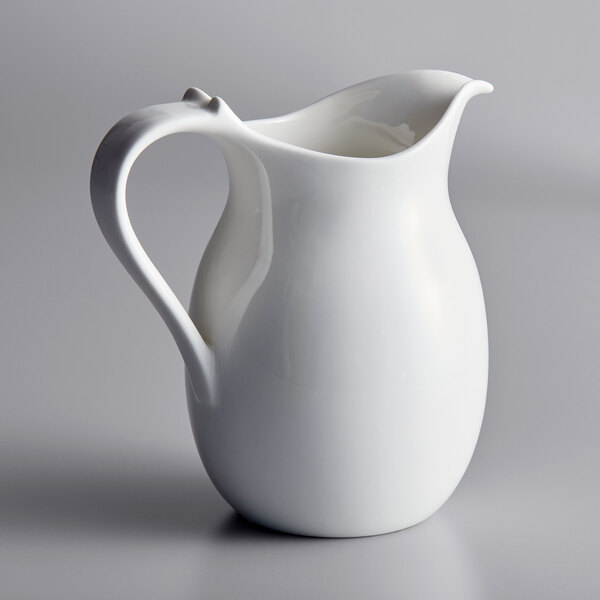 A white RAK Porcelain pitcher with a handle.