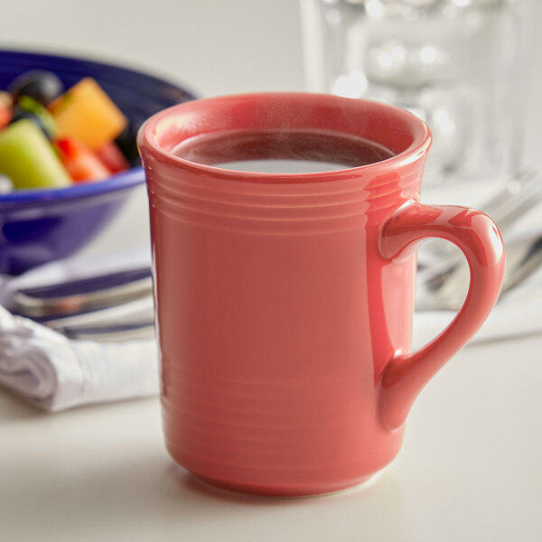 A close-up of a Tuxton Concentrix Cinnebar mug filled with a red liquid.