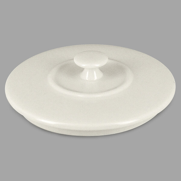 The sand white porcelain lid for a RAK Porcelain Chef's Fusion mini cocotte with a round handle.