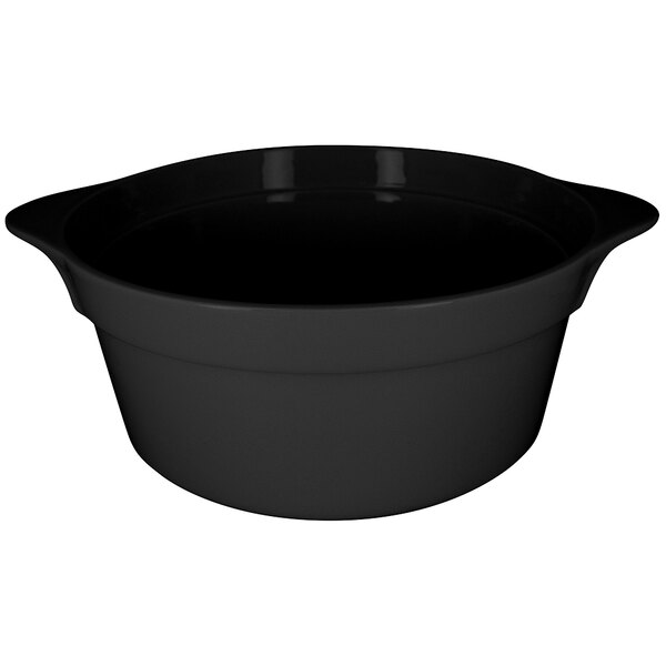 A black round porcelain cocotte with handles.