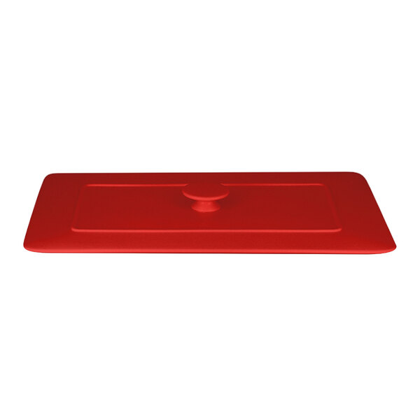 A red rectangular porcelain lid with a round knob.