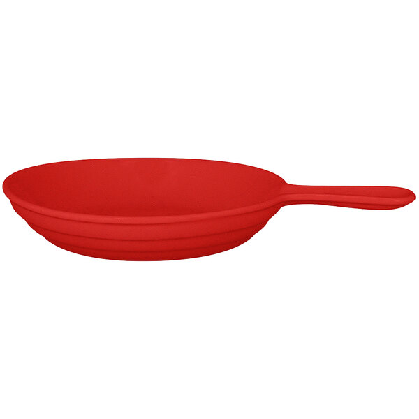 A red RAK porcelain frying pan with a handle.