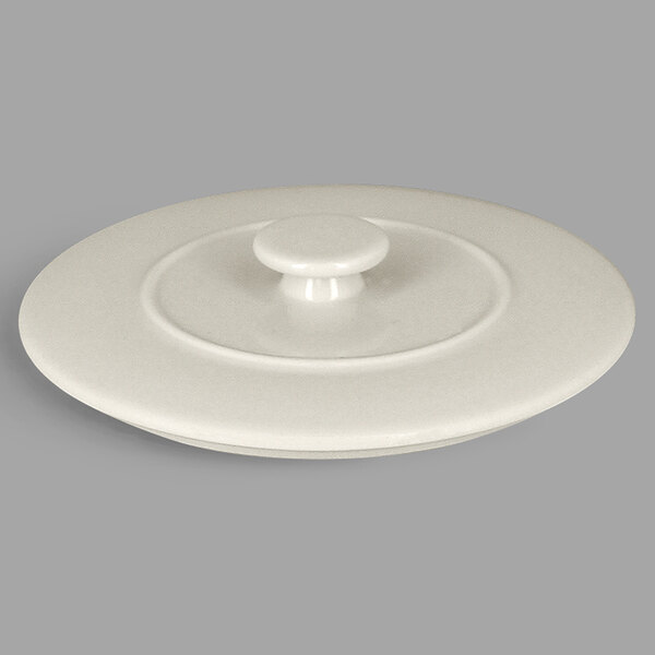 A white round porcelain lid with a round handle.