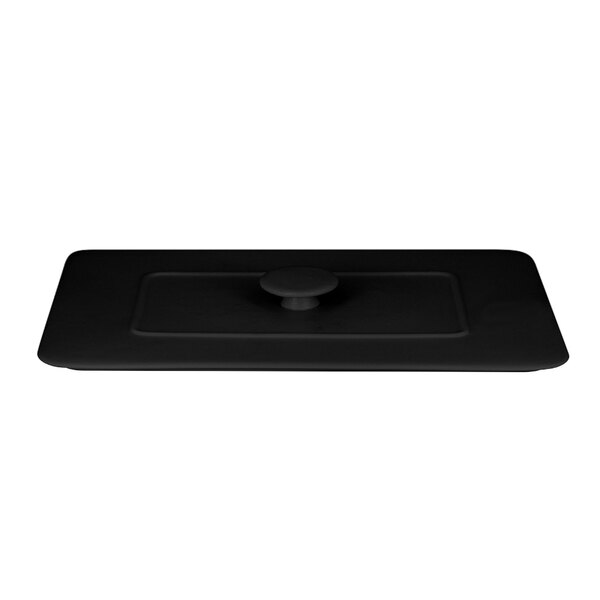 A black rectangular porcelain lid with a round button on top.