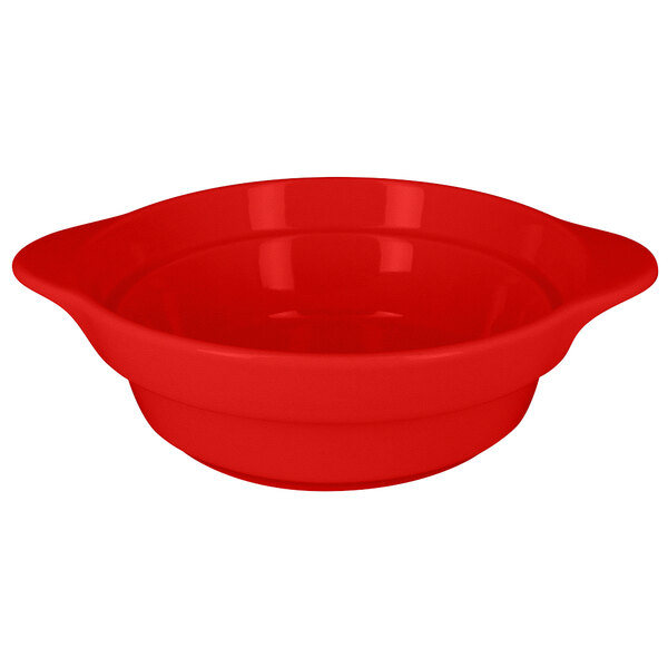 A red porcelain bowl with a handle.