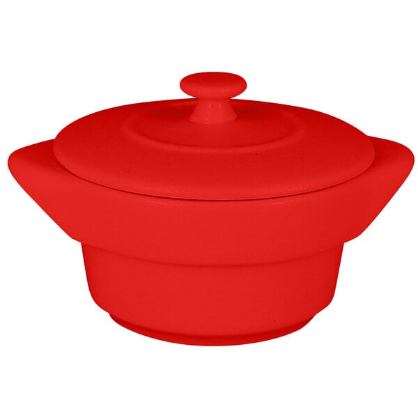 A red porcelain cocotte with a lid.