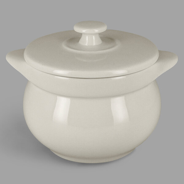 A white porcelain tureen with a round top and lid.