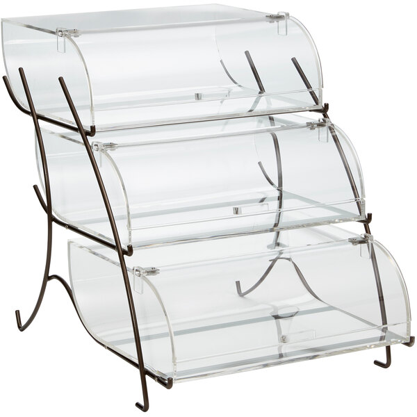 A clear acrylic three-tiered pastry display case with black metal legs.