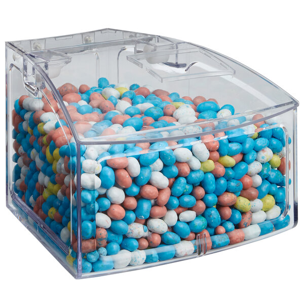 A clear plastic Rosseto bulk bin container with a scoop inside.