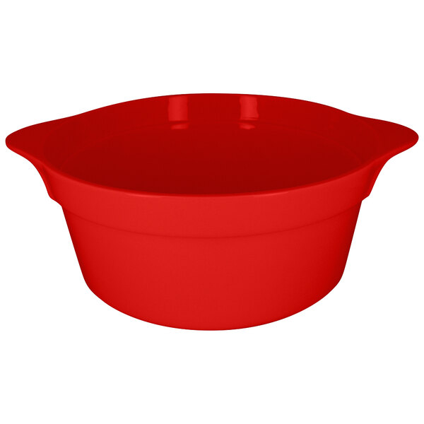 A red porcelain cocotte with handles on a white background.
