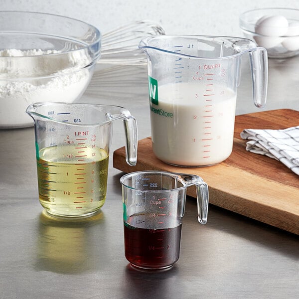 A clear plastic measuring cup, a clear plastic measuring cup, and a clear plastic measuring cup on a white background.