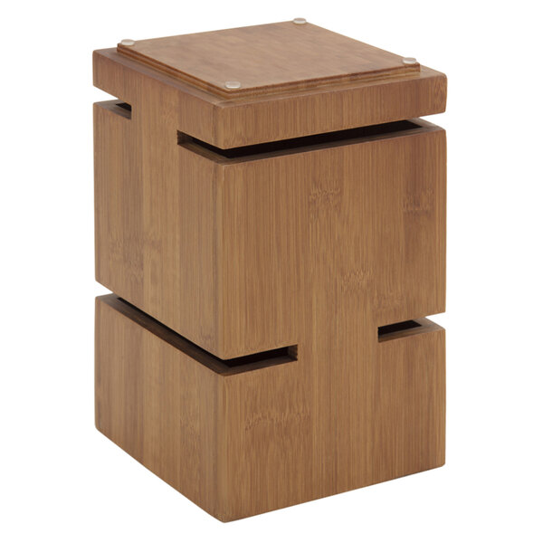 A Bon Chef bamboo display riser with a square top and three compartments.