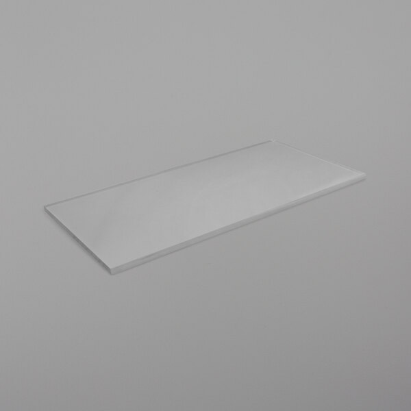 A rectangular clear plastic shelf on a white surface.