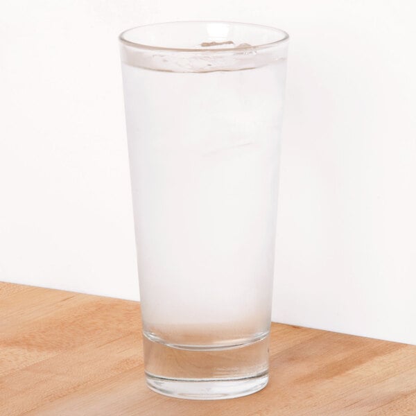 A Libbey Elan drinking glass filled with water on a table.