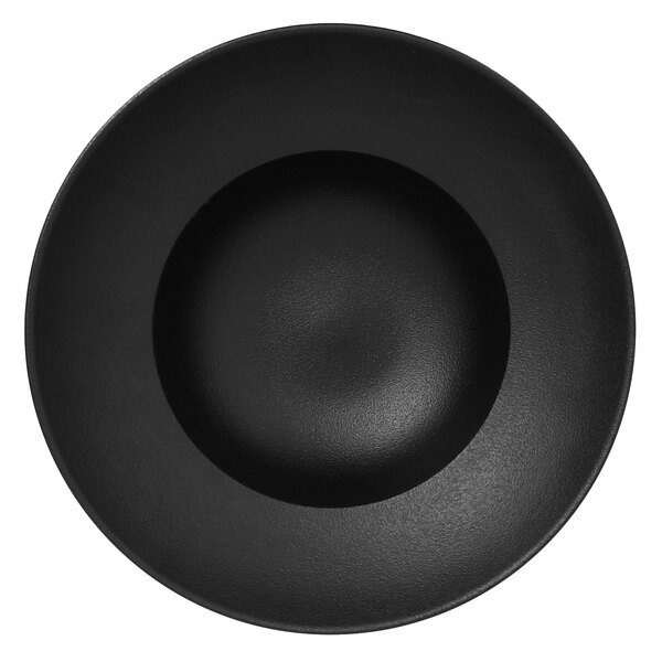 A close-up of a RAK Porcelain Neo Fusion Volcano Black extra deep plate with a round black center.