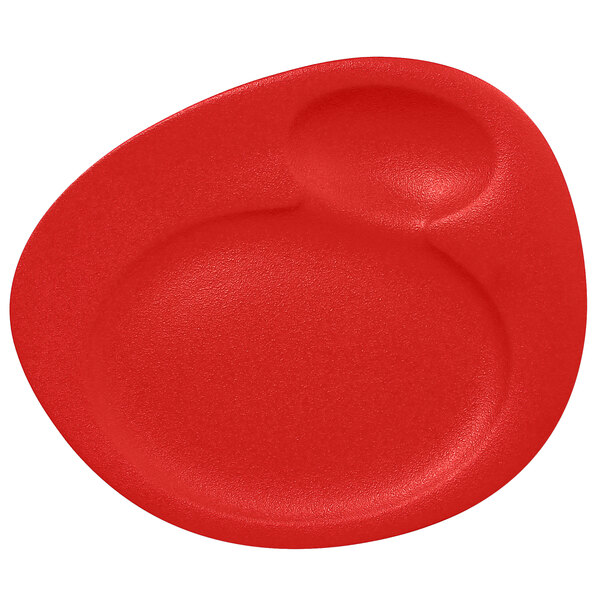 A red porcelain plate with two circles in the middle.