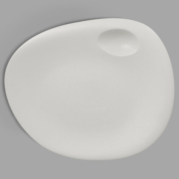 A white porcelain plate with a round hole in the middle.