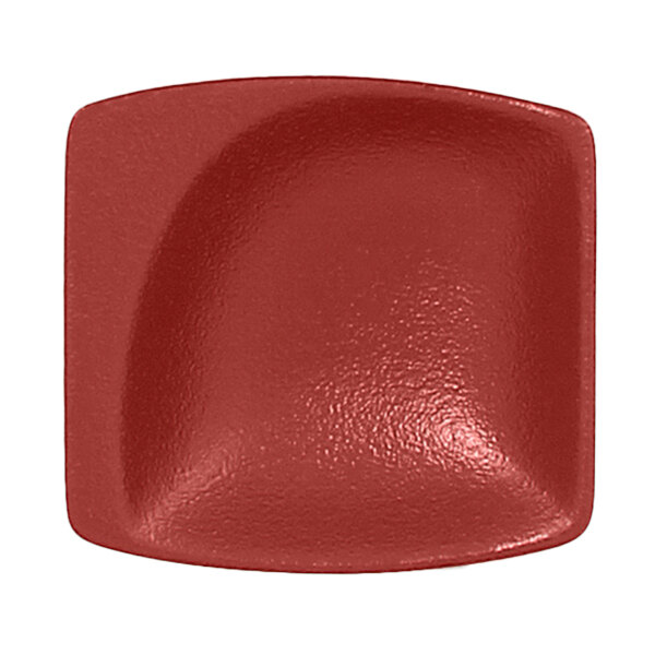 A close-up of a RAK Porcelain Magma Dark Red mini square dish with rounded edges.