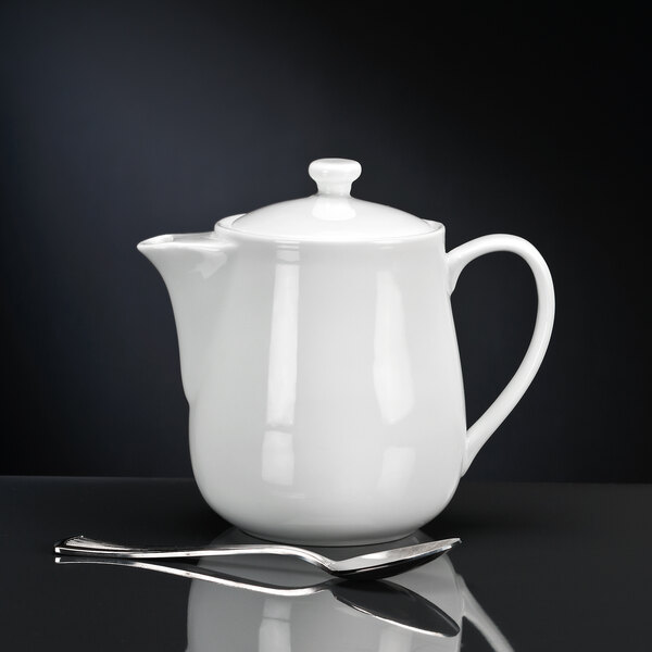 A white Libbey porcelain teapot with a lid.