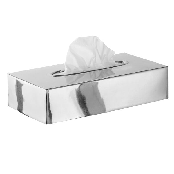A Focus Hospitality polished stainless steel flat tissue box cover on a counter with tissue paper inside.
