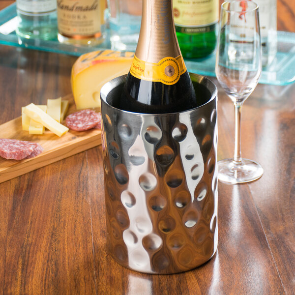 A Tablecraft stainless steel wine cooler with a bottle inside.