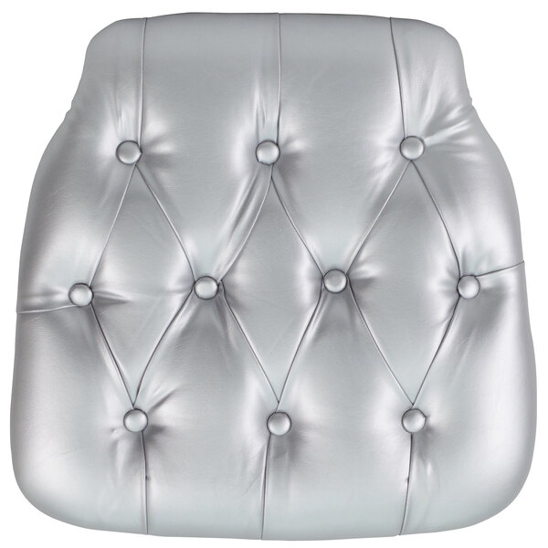A silver tufted chair cushion with buttons.