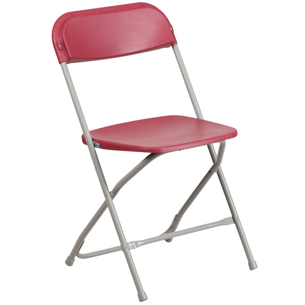 A Flash Furniture red plastic folding chair with a metal frame.
