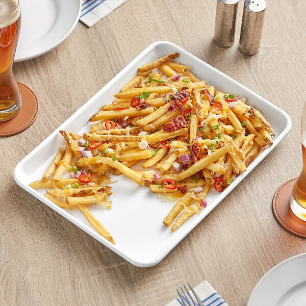 A Baker's Mark white non-stick wire rim aluminum sheet tray with french fries on it.