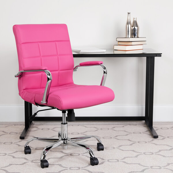 A Flash Furniture pink quilted vinyl office chair in front of a black desk.