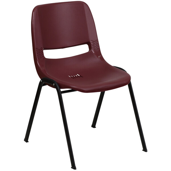 A burgundy plastic Flash Furniture Hercules Series stack chair with black legs.