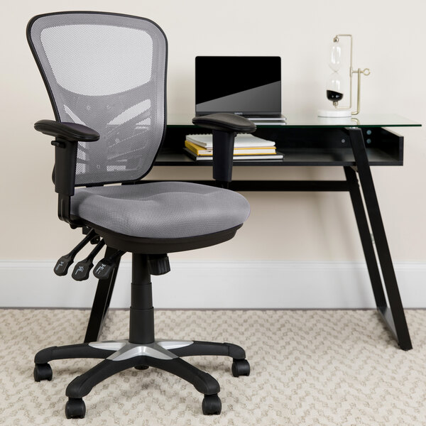 A Flash Furniture gray mesh office chair next to a desk.